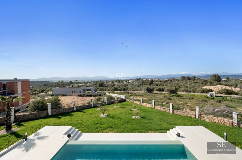Exterior view of a modern villa with infinity pool, expansive terraces, and lush landscaping. Minimalist and elegant architecture.