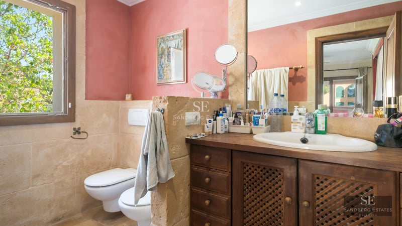 Exterior of a modern villa with a pool, minimalist design, large windows, and manicured landscaping.