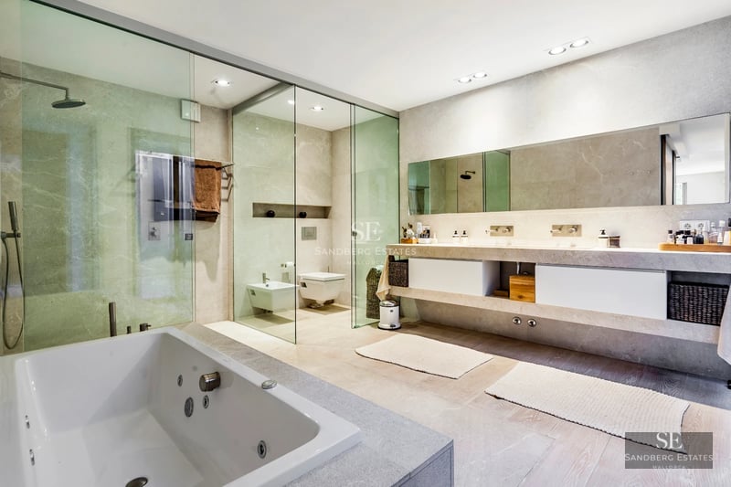 Expansive terrace with infinity pool and ocean views. Modern design, elegant furniture, and lush greenery. Relaxing and luxurious ambiance.