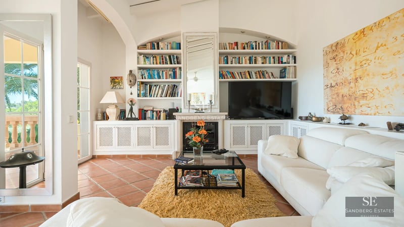 Exterior view of modern villa with infinity pool, lush garden, expansive terraces, and contemporary architectural design.