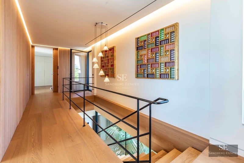 Image of a modern villa with a pool. Minimalist architecture, large windows, reflective pool and lush vegetation.