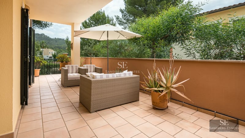 Aerial view of modern villa featuring infinity pool, spacious terraces, minimalist design, and lush gardens. High-quality finishes.