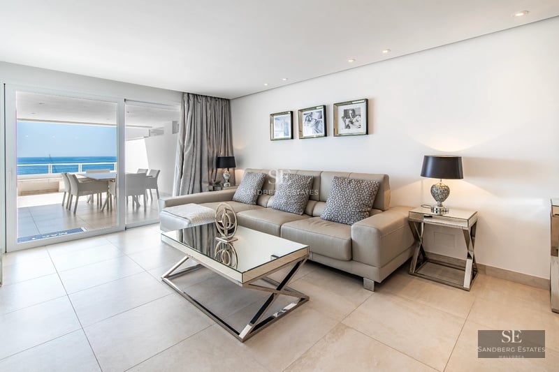 Exterior view of a modern villa with reflecting pool. Minimalist design, large windows, and lush gardens.