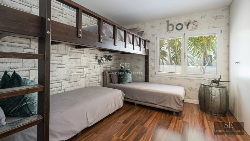 Exterior view of a modern villa featuring a swimming pool, landscaped garden, and expansive outdoor living spaces.