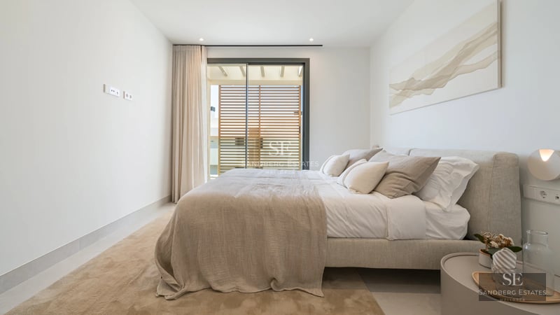 Bright living room with balcony and sea view. Modern design, wooden floors, and elegant furniture. Ideal for investment.