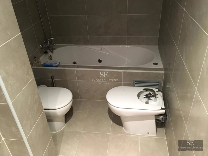 Vue extérieure d'une villa moderne avec piscine à débordement, entourée de verdure. Design architectural élégant et finitions de haute qualité.