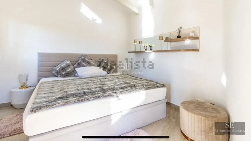 Exterior view of a modern villa with infinity pool, surrounded by lush vegetation. Minimalist architecture and natural light.
