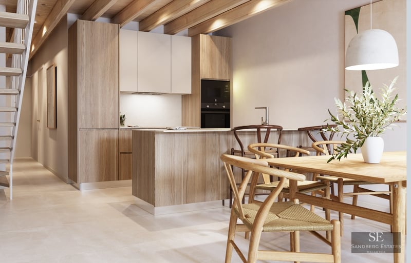 Modern kitchen featuring exposed wooden ceiling beams, a central island with stools, and an adjacent wooden dining table.