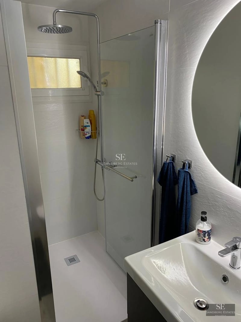 Expansive terrace with infinity pool, sun loungers, and panoramic views. Modern design with glass railings and lush vegetation.