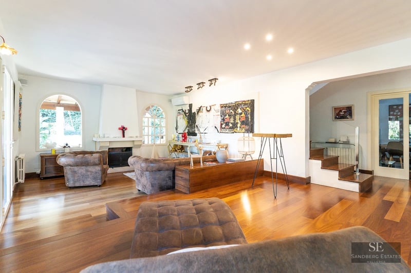 Spacious living room featuring floor-to-ceiling windows, panoramic sea views, modern and elegant furniture, and abundant natural light.