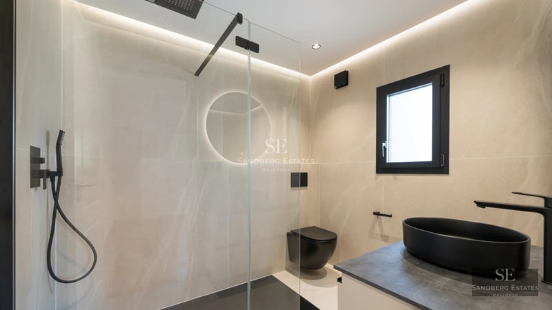 Exterior view of a modern villa featuring an infinity pool, lush garden, and natural stone facade. Minimalist architecture and expansive glass windows.