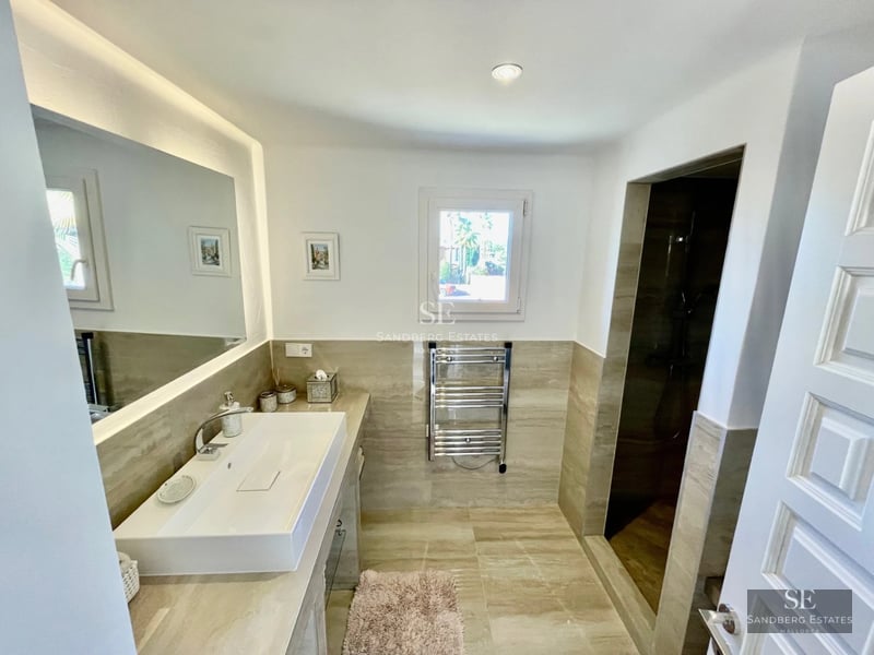 Spacious terrace with pool, sun loungers, and panoramic views. Modern and elegant design with high-quality materials.