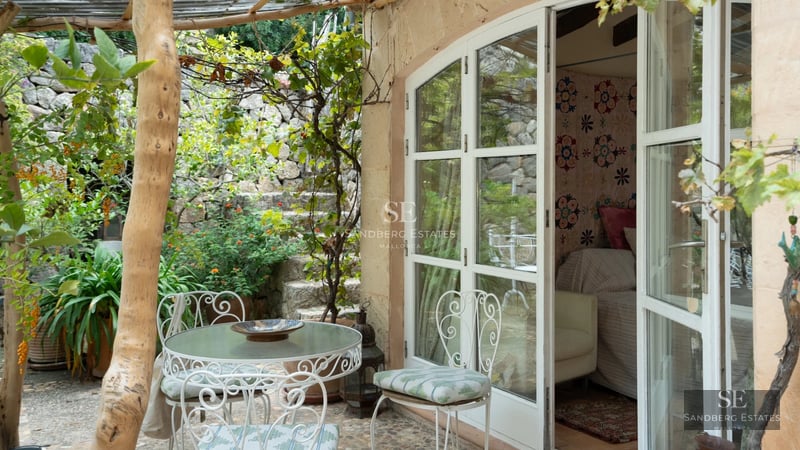 Spacious living room with pool access. Features include large windows, white sofas, and a modern design. Bright and welcoming space.