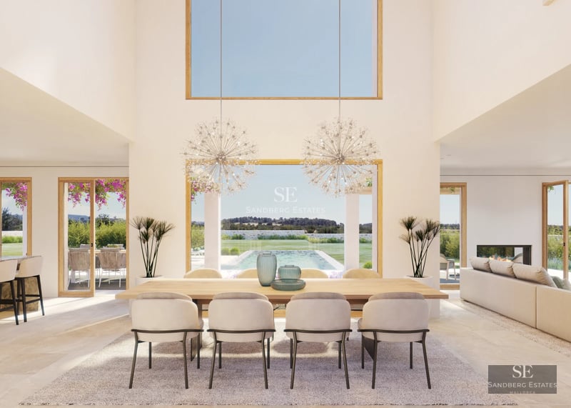 Spacious living room with large windows overlooking a modern pool. Designer sofas and abundant natural light.