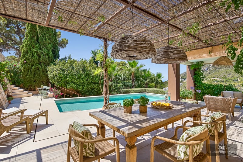 Expansive terrace with infinity pool and panoramic views. Modern, minimalist design with stylish outdoor furniture and lush vegetation.