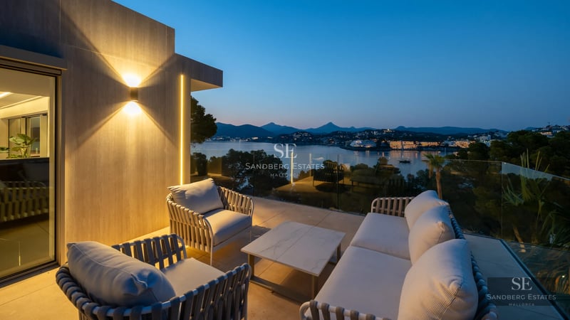 Exterior view of a modern villa featuring an infinity pool, lush garden, and minimalist architecture with large windows.