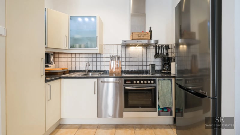 Exterior view of modern villa with infinity pool, lush garden, and sleek architectural design. Large windows and terraces.