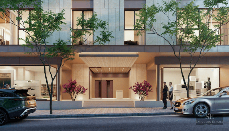 Ground floor of a modern building with central entrance, glass storefronts, sidewalk trees, and luxury cars.