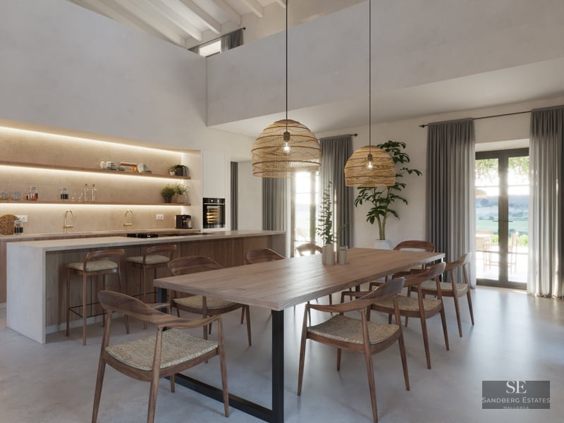 Spacious dining area with a long wooden table, wicker pendant lights, and a modern open-plan kitchen in the background.