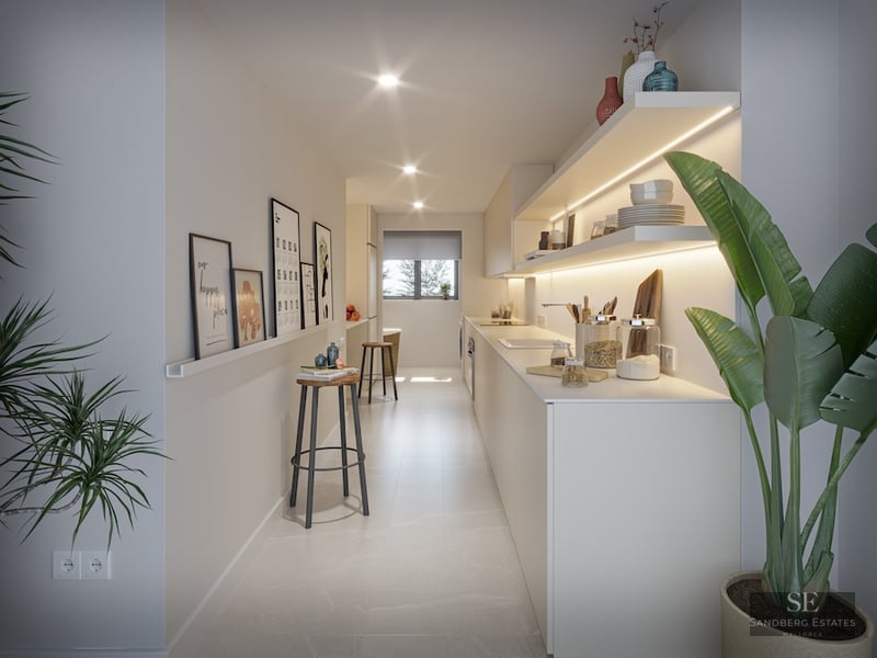Bright, narrow modern kitchen with white cabinets, illuminated open shelves, minimalist stools, and indoor plants.