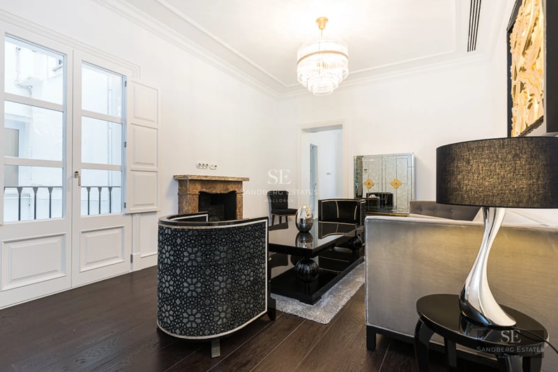 Bright living room with large windows, modern sofas, elegant coffee table, and panoramic sea views. Minimalist and sophisticated design.