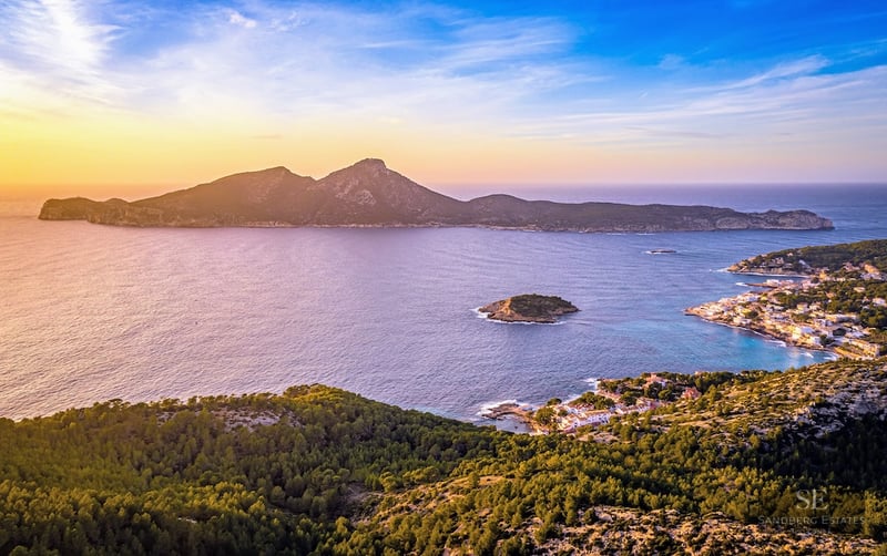Aerial view of the Mediterranean Sea and Dragonera Island at sunset with golden light across the coastline.