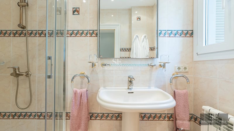 Exterior view of a modern villa with a pool, surrounded by greenery and minimalist architectural design. Natural lighting.