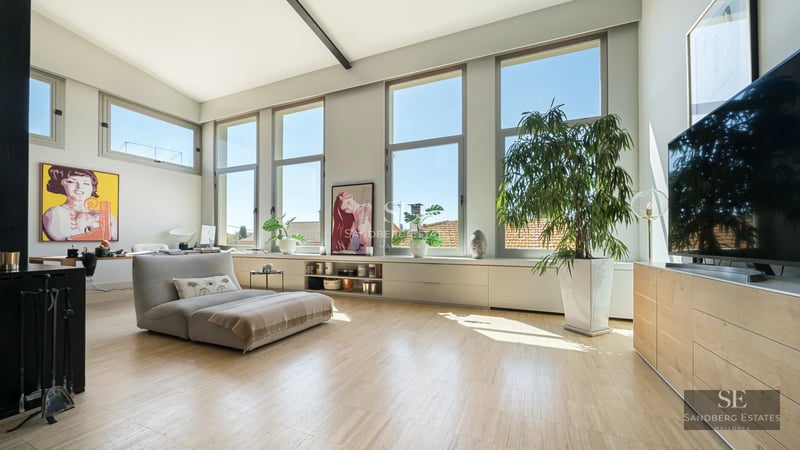 Spacious terrace with panoramic sea views, modern furniture, glass railing, wooden floor. Luxurious and relaxing atmosphere.