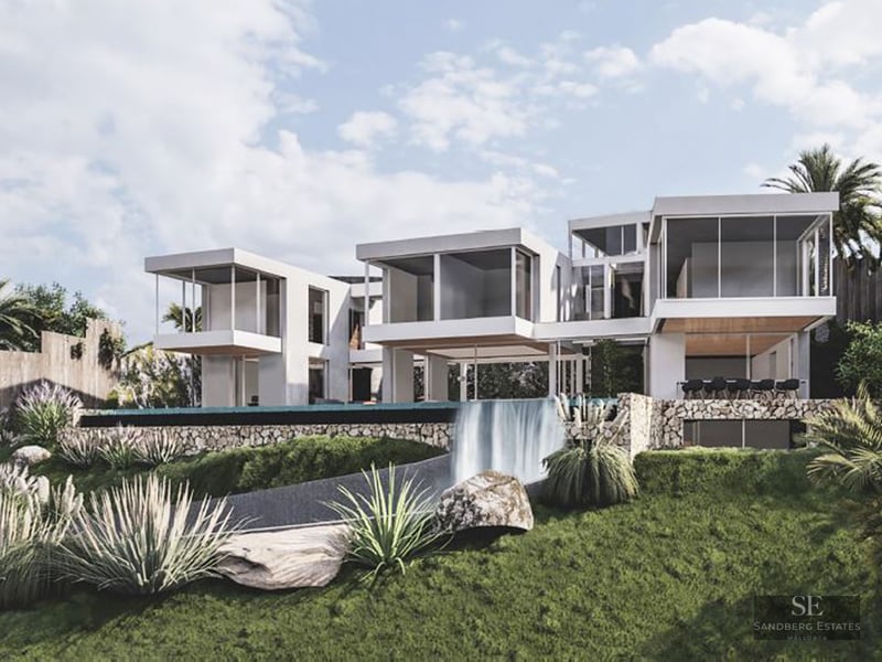Modern white multi-level villa with cantilevered rooms and an infinity pool waterfall spilling into a landscaped garden.