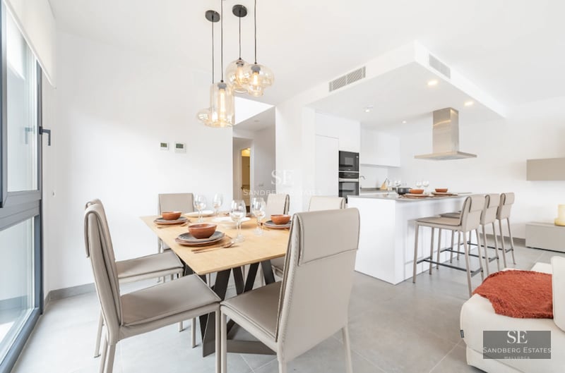 Spacious balcony with glass railing, panoramic sea view. Light floors and modern furniture.