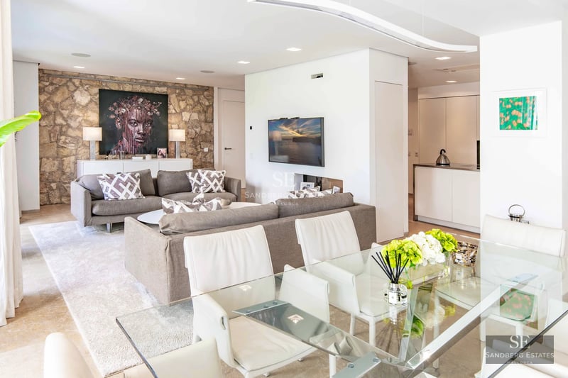 Exterior of a modern villa featuring an infinity pool, spacious terraces, and panoramic views. Minimalist design with high-quality finishes.