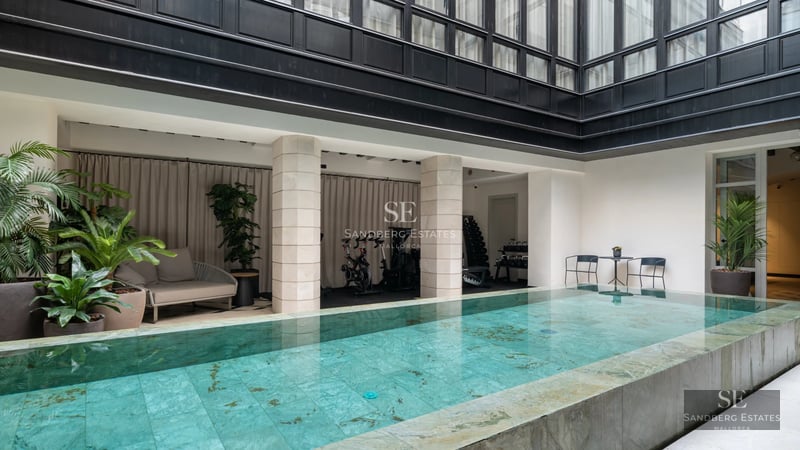 Exterior of modern villa with pool, large windows and minimalist architectural design. Lush garden and terrace.