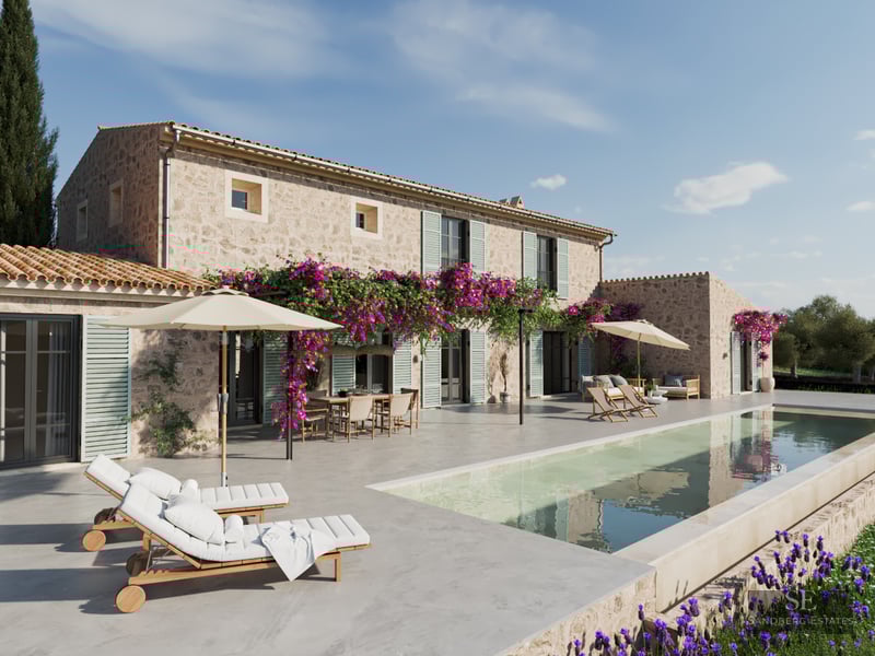 Large swimming pool next to a traditional stone villa with purple bougainvillea flowers and white sun loungers.
