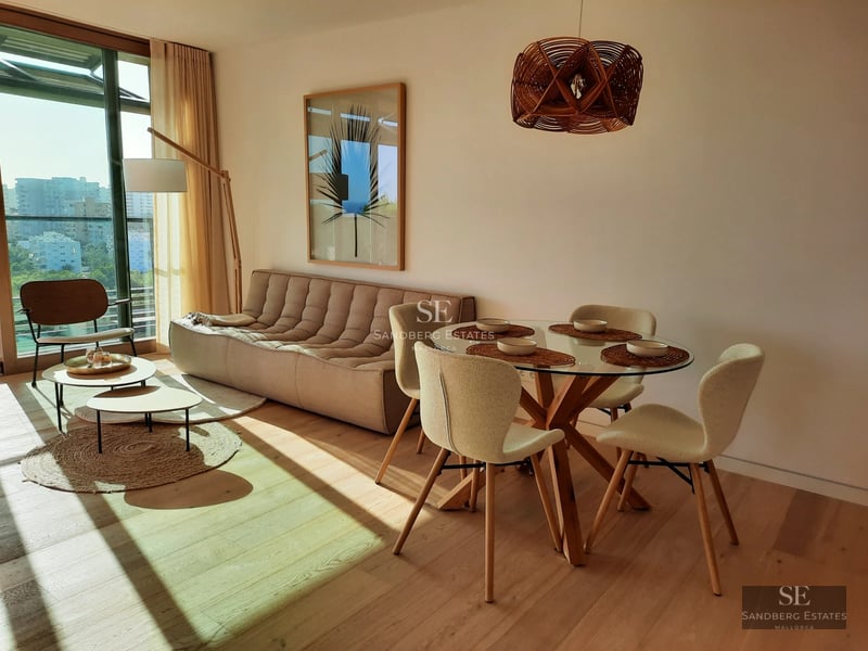 Expansive terrace with pool, lounge chairs, and view. Modern architecture featuring large windows and lush landscaping.