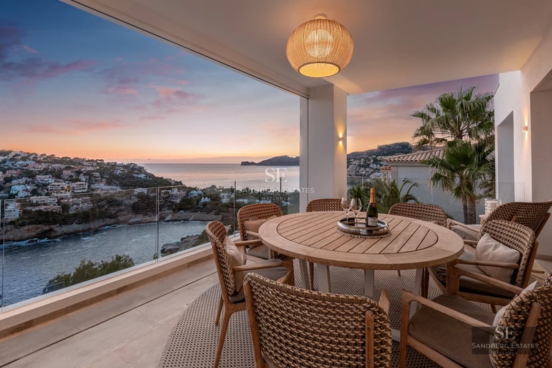 Exterior view of a modern villa with a pool, large windows, and landscaped terrace. Minimalist and elegant design.