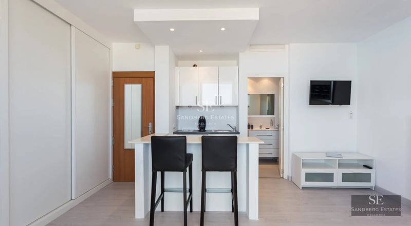 Exterior of modern villa featuring an infinity pool, lush gardens, and panoramic views. Minimalist architecture with expansive windows.