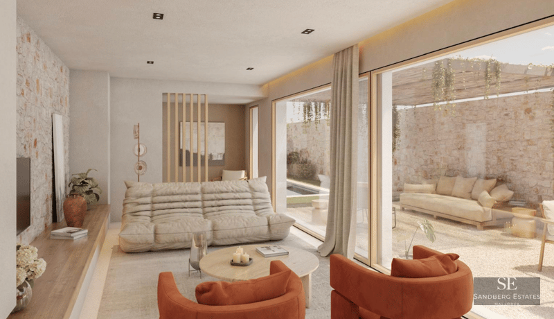 Modern living room featuring a beige sofa, burnt orange armchairs, and floor-to-ceiling glass doors opening to a stone terrace.