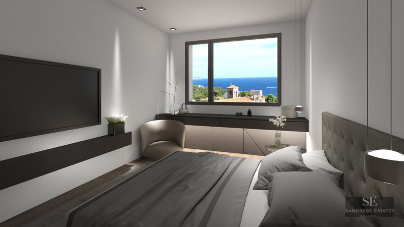 Modern bedroom featuring a grey bed, wall-mounted TV, and a window framing a bright blue sea and coastal landscape.