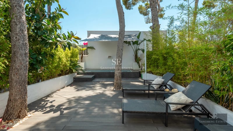 Expansive terrace featuring an infinity pool, sun loungers, and ocean views. Modern architecture and minimalist design.