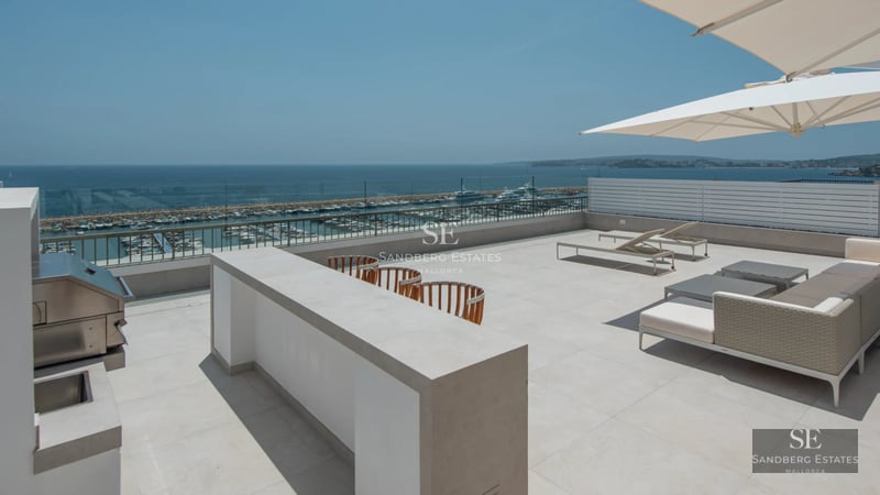 Panoramic view of modern villa featuring an infinity pool, expansive windows, terrace, and lush vegetation. Contemporary design and spectacular views.