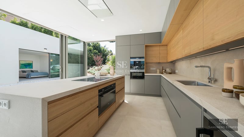 Expansive terrace featuring an infinity pool with panoramic sea views. Modern architecture, clean lines, and stylish outdoor furniture.