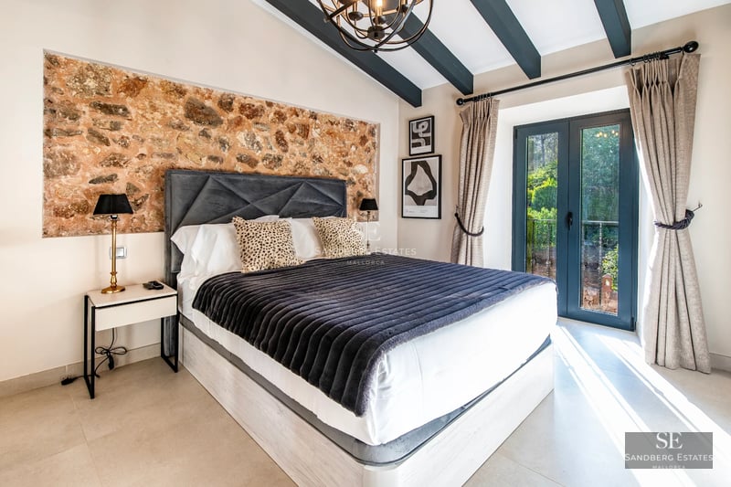 Spacious living room with panoramic windows, light wood floors, modern designer furniture and stunning sea views.