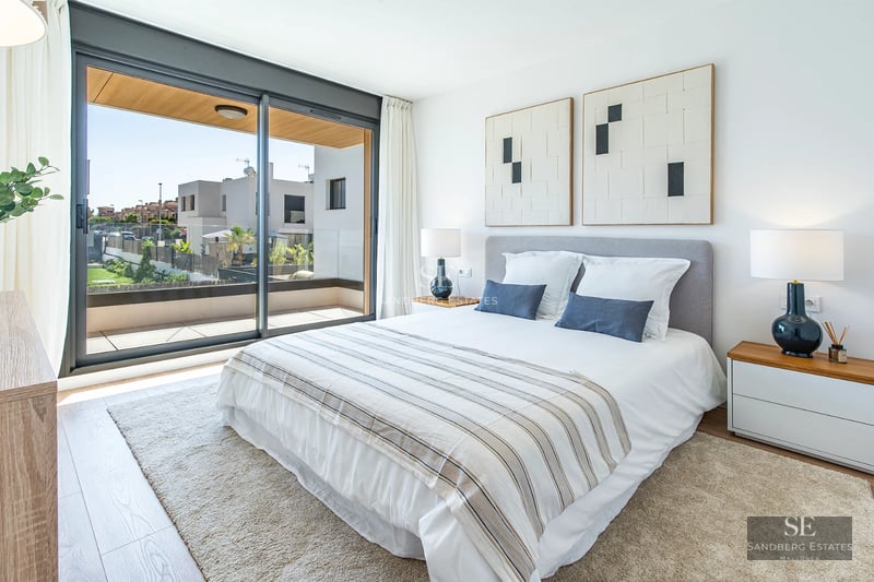 Exterior view of a modern house with a pool, manicured garden, and large windows providing ample natural light.