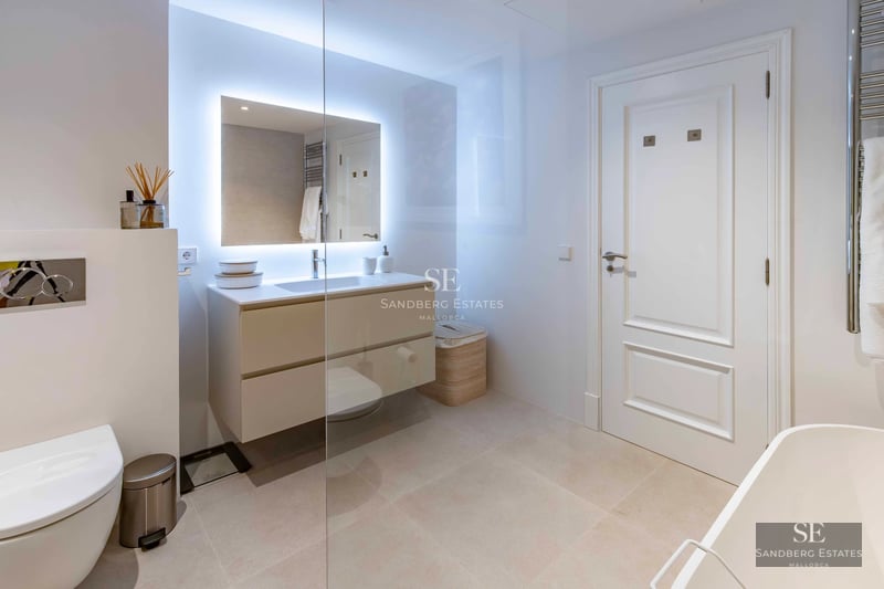 Exterior view of a modern villa with infinity pool, lush garden, and expansive terraces. Minimalist architecture with large windows.