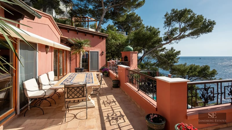 Expansive terrace featuring an infinity pool, stylish loungers, and panoramic sea views. Modern and minimalist design.