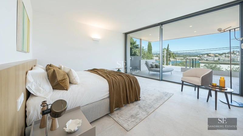 Bright interior with sea views. Modern design, light wood floors, large windows, and elegant furniture.