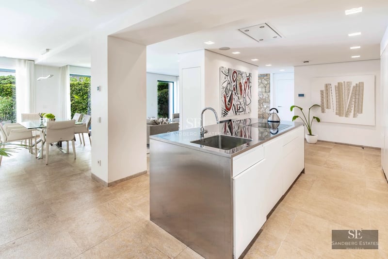 Exterior view of a modern villa with infinity pool, surrounded by greenery. Sleek architecture and contemporary design.