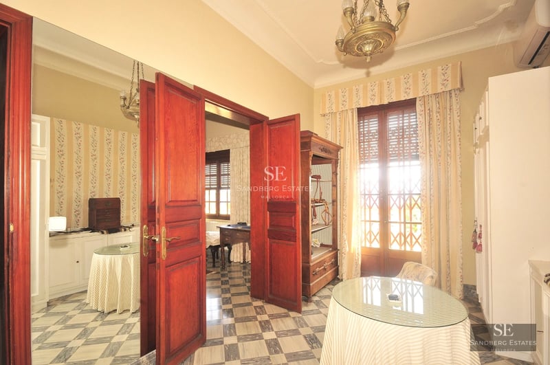 Exterior view of a modern villa featuring an infinity pool, lush garden, and elegant architectural design. Natural lighting.