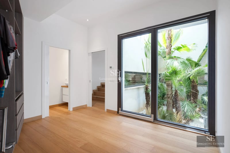 Wide view of a modern villa with pool, garden, and large windows. Minimalist and elegant architectural design.