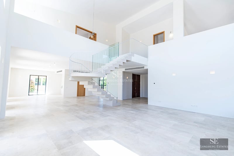 Exterior view of modern villa with infinity pool, lush garden, and expansive terraces. Minimalist architectural design.